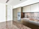 Modern kitchen with sleek cabinetry and marble countertop