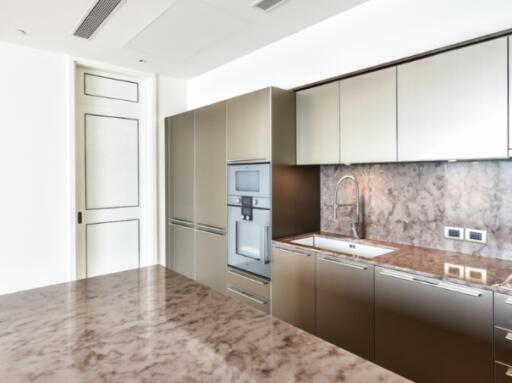 Modern kitchen with sleek cabinetry and marble countertop