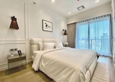 Modern bedroom with bed, nightstand, and large window