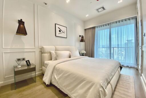 Modern bedroom with bed, nightstand, and large window