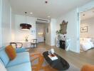 Modern living room with adjoining dining area and view into bedroom