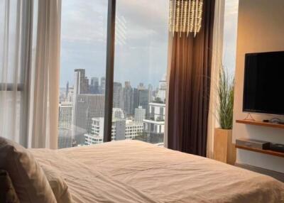 Modern bedroom with large windows and city view