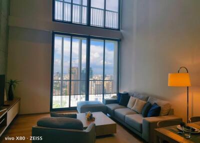 Modern living room with a large window and city view