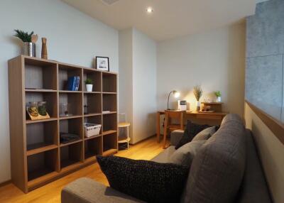 Cozy living area with bookshelf, sofa and desk