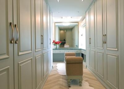 Spacious walk-in closet with ample storage and seating