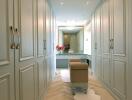 Spacious walk-in closet with ample storage and seating