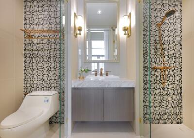 Modern bathroom with mosaic tile walls and glass shower enclosure