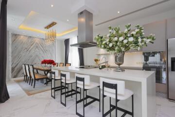 Modern kitchen and dining area with white countertops and elegant decor