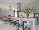 Modern kitchen and dining area with white countertops and elegant decor