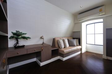 Cozy seating area with built-in desk and shelves