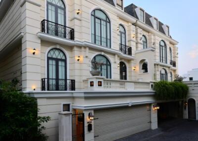 Elegant multi-story residential building with a paved driveway