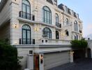 Elegant multi-story residential building with a paved driveway