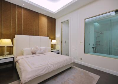 Spacious bedroom with modern decor and a view into the en-suite bathroom