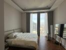 Spacious bedroom with large windows and city view