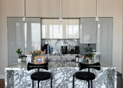 Modern kitchen with marble island and contemporary lighting