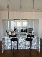 Modern kitchen with marble island and contemporary lighting