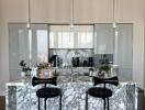 Modern kitchen with marble island and contemporary lighting