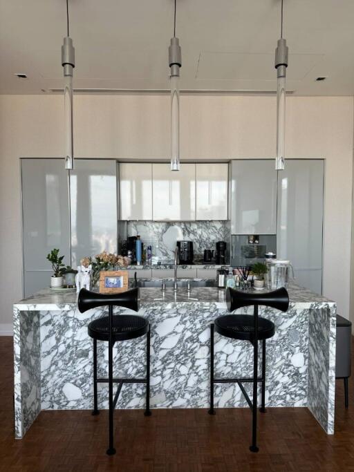 Modern kitchen with marble island and contemporary lighting