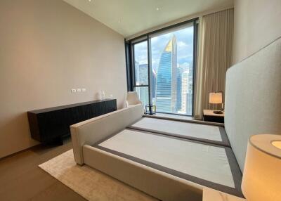 Modern high-rise bedroom with large windows and city view