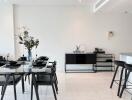 Modern dining area with glass-top table and black chairs