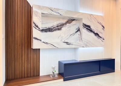 Modern living room with marble wall feature and wooden accent