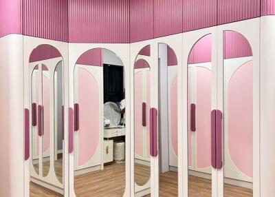 Bedroom with pink and white wardrobes