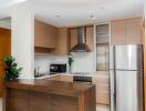 Modern kitchen with wooden cabinets, stainless steel appliances, and a kitchen island