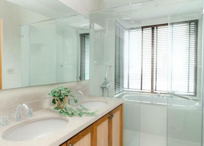 Modern bathroom with double sinks and glass shower