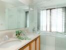 Modern bathroom with double sinks and glass shower