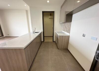 Modern kitchen with marble countertop and ceramic flooring