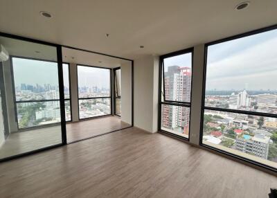 Spacious living room with large windows and a city view