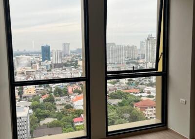 Spacious living room with large windows and city view