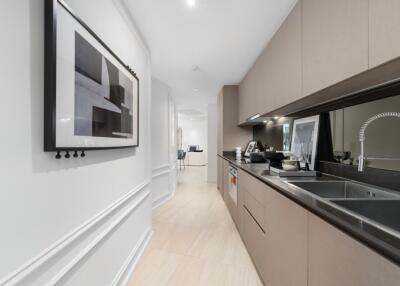 Modern kitchen with sleek cabinetry and wall art