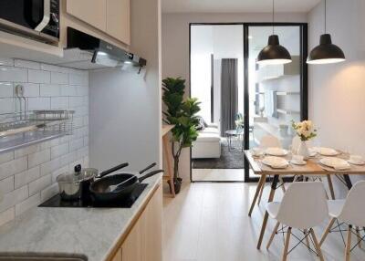 Modern kitchen and dining area with view of living room