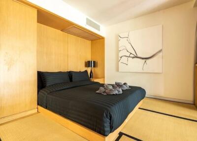 Modern bedroom with black bedding and wooden furnishings