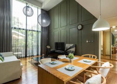 Modern living room and dining area with high ceilings