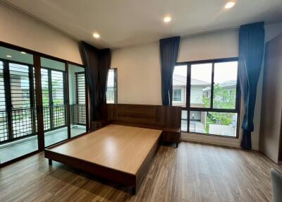 Modern bedroom with large windows and balcony view