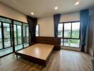 Modern bedroom with large windows and balcony view