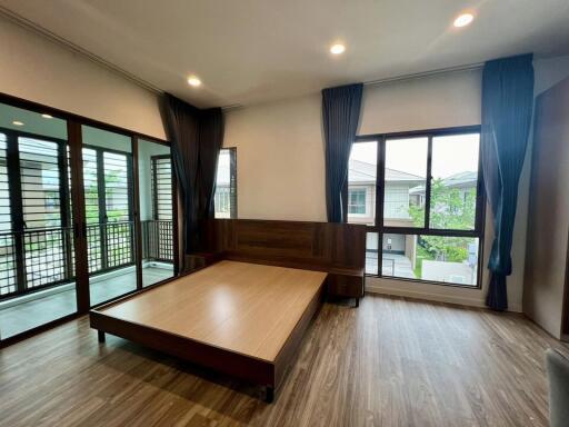 Modern bedroom with large windows and balcony view