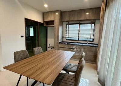 Modern dining area with a wooden table and chairs