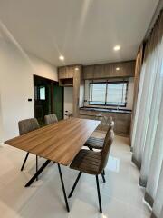 Modern dining area with a wooden table and chairs