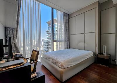 Bedroom with large windows and city view