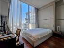 Bedroom with large windows and city view