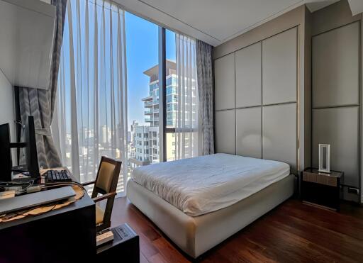 Bedroom with large windows and city view