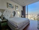 Modern bedroom with a large window and city view