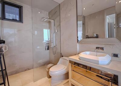 Modern bathroom with glass shower and large mirror