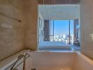 Modern bathroom with a view of a bedroom and cityscape