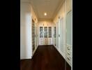 Spacious walk-in closet with built-in shelves and cabinets