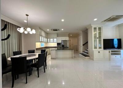 Open-concept kitchen and living space with dining area and modern furnishings