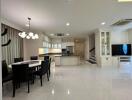 Open-concept kitchen and living space with dining area and modern furnishings